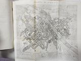 a map of a city in a book on a table