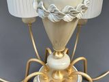 a table lamp that has a spider on top of it