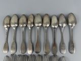 a lot of spoons and forks on the table