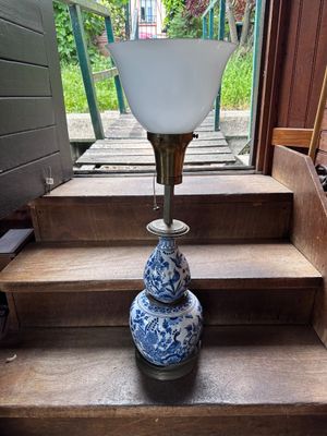 a blue and white vase sitting on a set of stairs