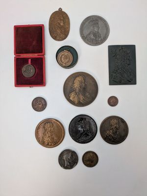 une image représentant une collection de pièces de monnaie et d'autres objets posés sur une surface blanche