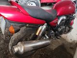 a red motorcycle that is parked in a garage