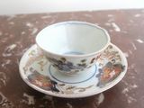 a cup and saucer sitting on a table
