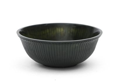 a black bowl that is sitting on a white surface
