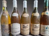 several bottles of wine are lined up on a table