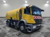 a large yellow truck that is parked in a room