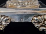 a close up of a silver plate on a table