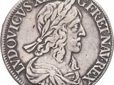 a close up of a silver coin with a woman ' s head on it