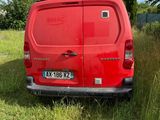 a red van that is parked in the grass