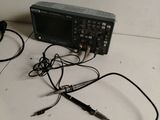 an image of a couple of wires connected to a radio on a table