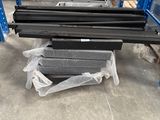 several pieces of steel are stacked on top of each other in a warehouse