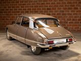 a brown car parked in a garage next to a brick wall