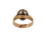 a close up of a gold ring with a diamond on it