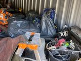 a pile of garbage in a storage room next to a ladder