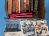 many old books in a box on a blue surface