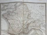 an old map of france in a book on a table