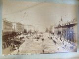 an old photo of a city street with people and horse drawn carriages