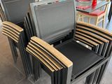 three chairs in a restaurant with a table and chairs in the background
