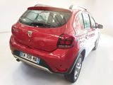 a red car that is parked in a white room