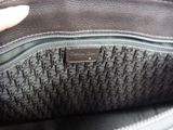 the inside of a black purse with a hand holding it