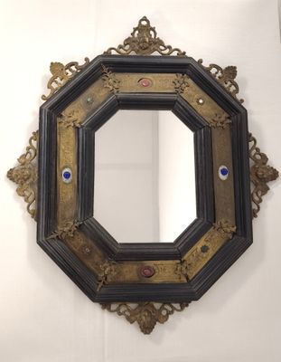 a black and gold frame with a blue eye on it