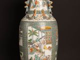 a vase that is sitting on a table in front of a black wall