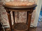 a wooden table with a marble top on a hard wood floor