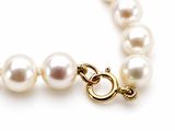an image of a white pearl necklace with a gold clasp