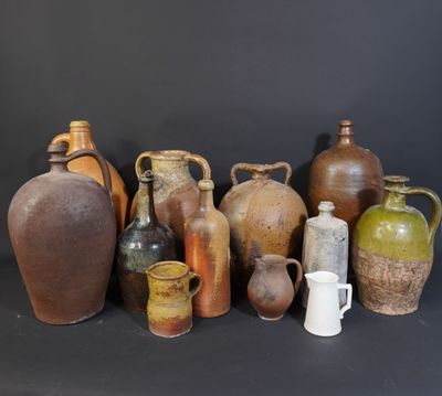 many different types of vases sitting on a table