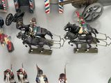 many figurines of soldiers on display in a glass case