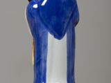 a blue and white vase with a gold crown on it