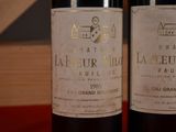 two bottles of wine sitting next to each other on a table