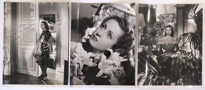 an old black and white photo of a woman with flowers in her hair