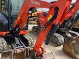 a red excavator that is sitting in the dirt