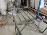 a metal bed frame that is in the middle of a room