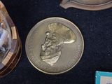 a gold coin with a picture of a chef on it