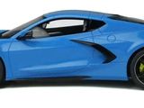 the blue sports car is parked on the white surface