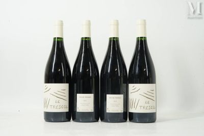 three bottles of wine are lined up on a table