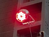 a red light that is on the side of a building