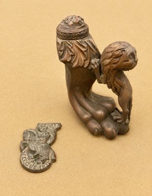 a small bronze statue of a woman holding a baby