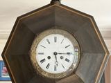 a clock hanging from the ceiling of a living room