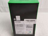 a close up of a box on a white surface with a green label on it
