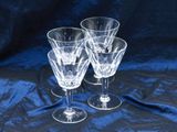 three wine glasses sitting on a blue cloth