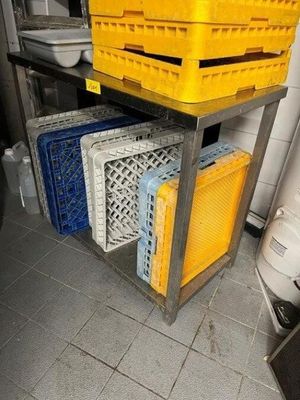 many crates stacked on top of each other in a kitchen