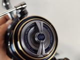 a person holding a fishing reel in their hand