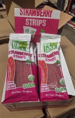two bags of strawberries sit in a cardboard box on a table