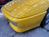 a yellow sports car parked in a parking lot