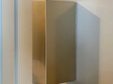 a metal object hanging on the wall in a bathroom