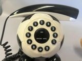 a black and white telephone sitting on a table