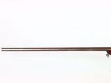 a rifle with a wooden barrel on a white background